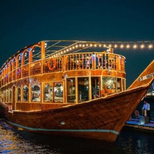 Royal dhow cruise at Deira Creek Dubai featuring traditional wooden boat, buffet dinner, calm evening sailing, and scenic old Dubai waterfront views